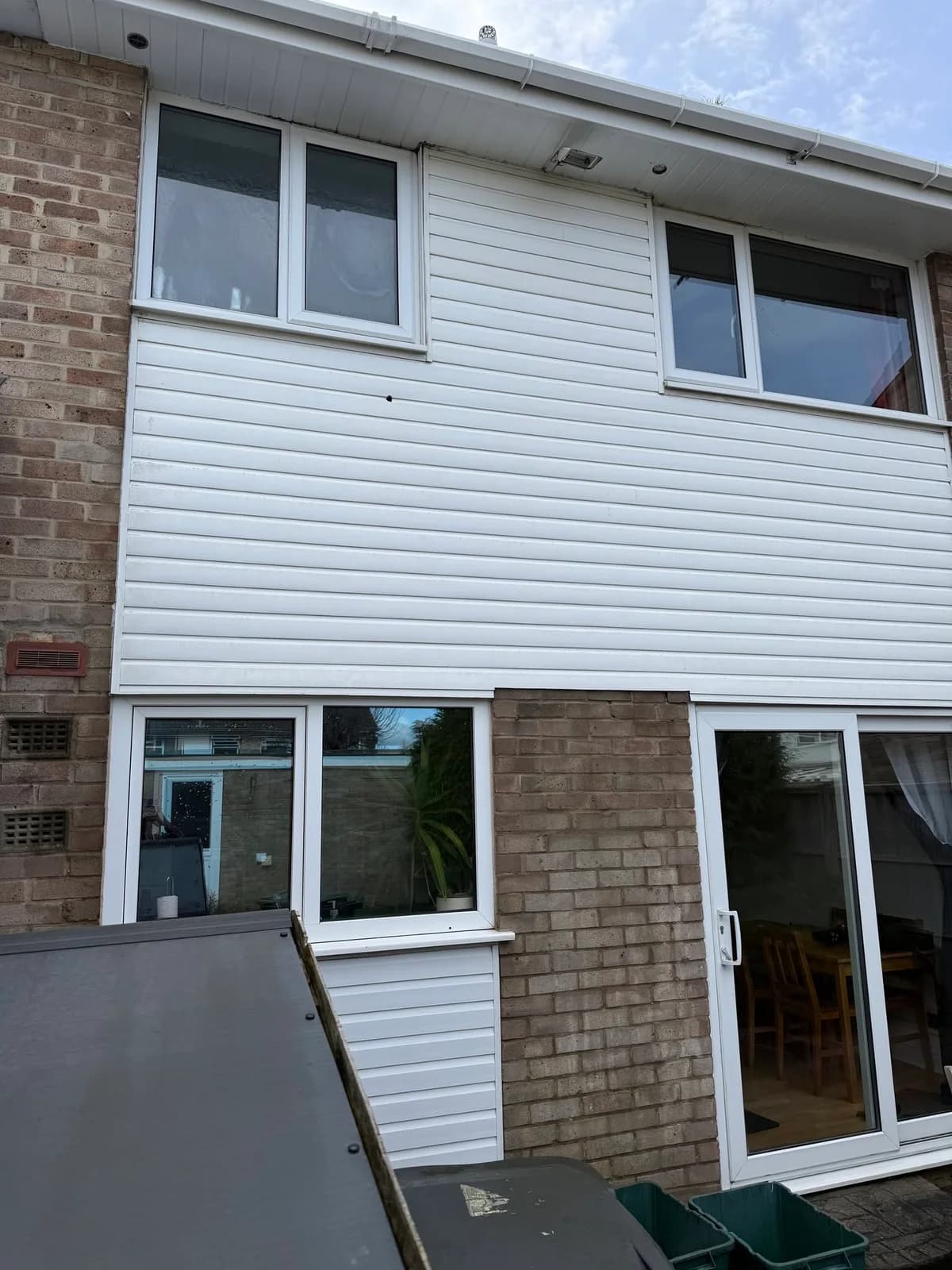 The same white exterior cladding after cleaning by our team